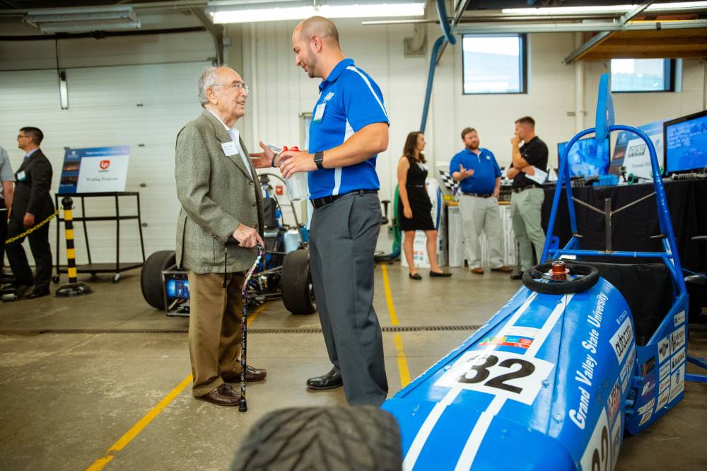 Seymour Padnos speaking with an engineering student.